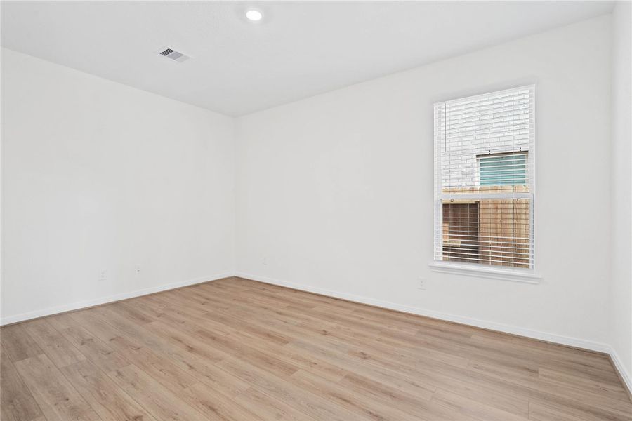 Tucked peacefully at the front of the home, this Den offers a quiet workspace with vinyl plank flooring, high ceilings, large window with blinds, and custom paint for a polished finish. Tucked peacefully at the front of the home, this Den offers a quiet workspace with vinyl plank flooring, high ceilings, large window with blinds, and custom paint for a polished finish.