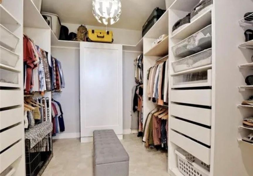 Spacious closet featuring a chandelier Spacious closet featuring a chandelier