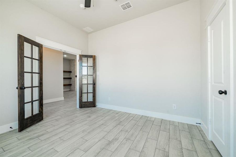 Office featuring wood finish French doors and tile floors Office featuring wood finish French doors and tile floors