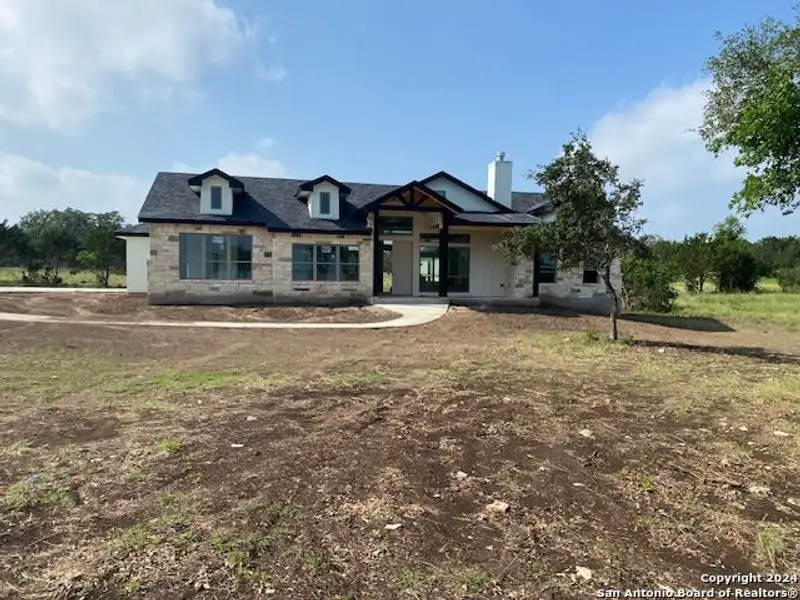 Front exterior of a new home in , Bandera, TX, highlighting curb appeal (Image 2).