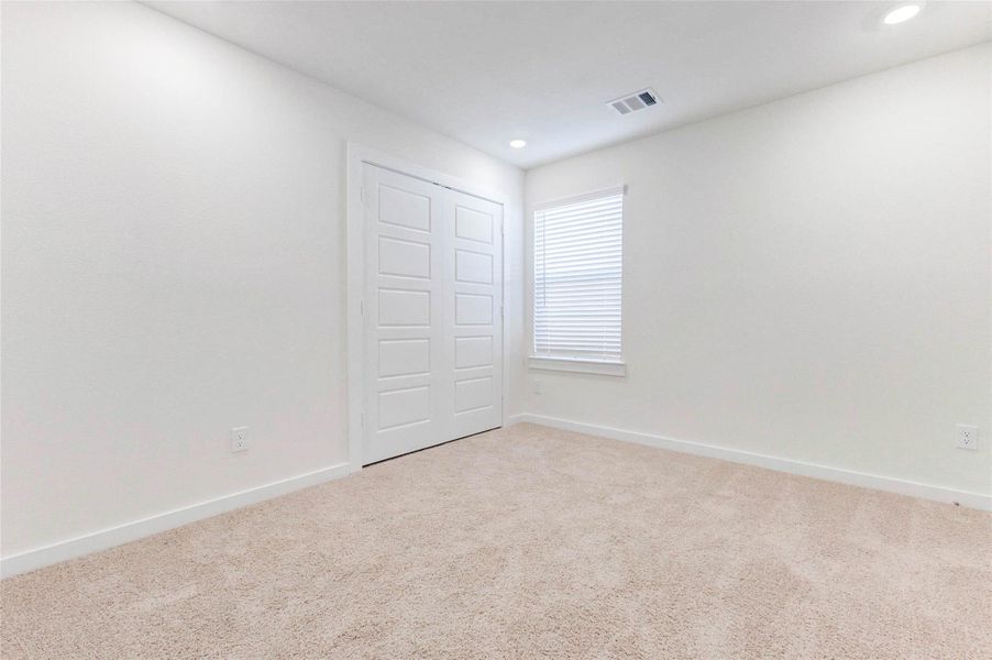 This fourth bedroom offers even more flexibility within the floor plan. Whether used for rest, play, or productivity, the soft carpet, wide closet doors, and soothing wall color provide a neutral palette for any design. This fourth bedroom offers even more flexibility within the floor plan. Whether used for rest, play, or productivity, the soft carpet, wide closet doors, and soothing wall color provide a neutral palette for any design.