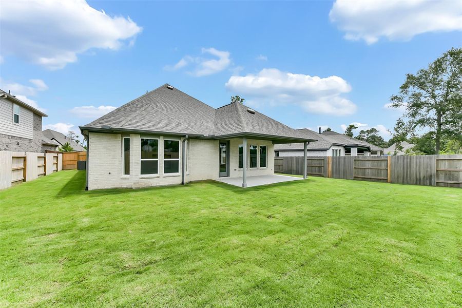 Front exterior of a new home in Evergreen 50', Conroe, TX, highlighting curb appeal (Image 1).