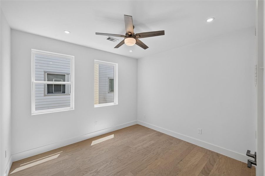 Secondary bedroom located in the third floor with natural lighting from the large windows, nice sized closet and full bathroom!