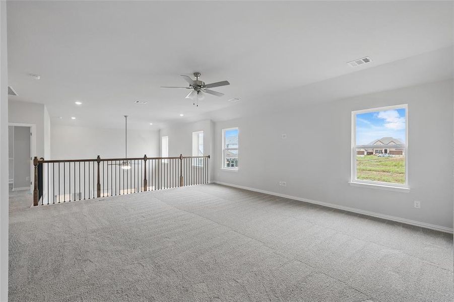 Carpeted spare room with ceiling fan and recessed lighting