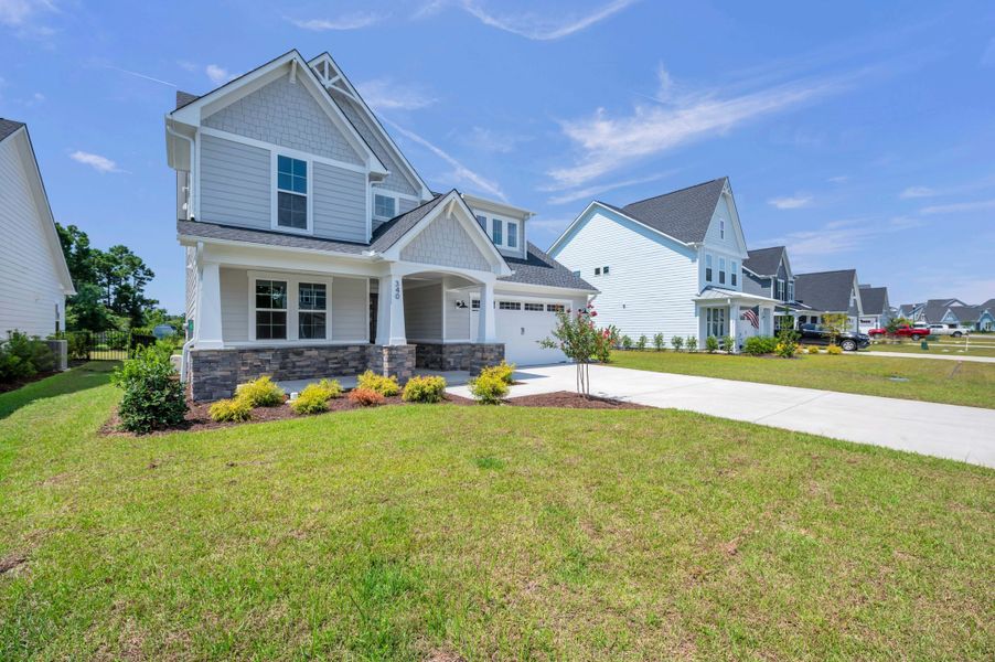 Representative exterior photo of a completed home built from the The Whitley by RobuckHomes in Windwater, Hampstead, NC (Image 35).
