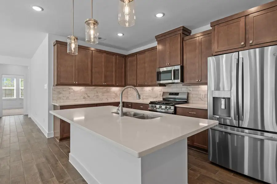 Furnished interior view inside a new home in Meridiana, Iowa Colony (Image 8).