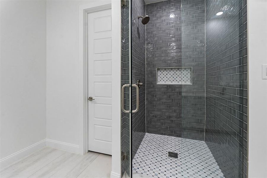 Bathroom with a shower with shower door