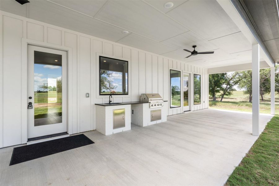 View of patio featuring an outdoor kitchen, a ceiling fan, and a sink View of patio featuring an outdoor kitchen, a ceiling fan, and a sink