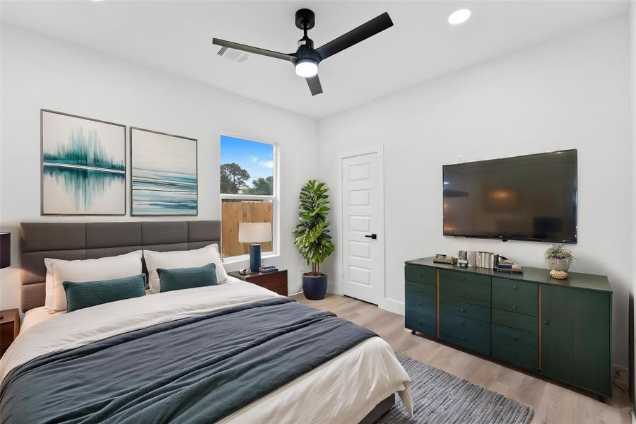 Virtually Staged: Wonderfully appointed secondary bedroom, featuring neutral paint, vinyl plank floors, recessed lighting, and a ceiling fan.