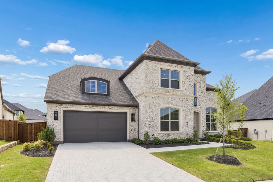 Front exterior of a new home in StarView, Prosper, TX, highlighting curb appeal (Image 2). Front exterior of a new home in StarView, Prosper, TX, highlighting curb appeal (Image 2).