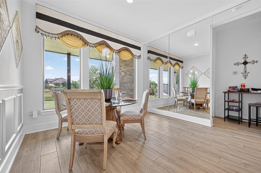 This dining area features large windows with stylish valances, offering plenty of natural light and scenic views. The space is enhanced by a mirrored wall, creating a sense of openness. The room includes elegant wood flooring and classic furnishings, perfect for a cozy dining experience. This dining area features large windows with stylish valances, offering plenty of natural light and scenic views. The space is enhanced by a mirrored wall, creating a sense of openness. The room includes elegant wood flooring and classic furnishings, perfect for a cozy dining experience.