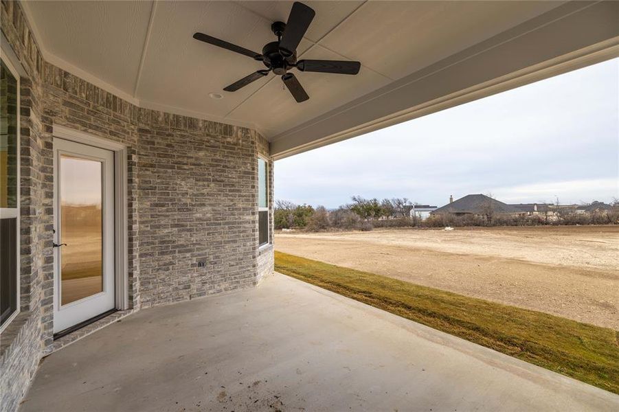 View of patio featuring ceiling fan