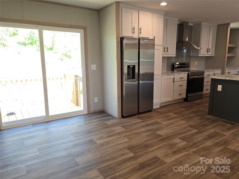 Dining area with outdoor deck access. Dining area with outdoor deck access.