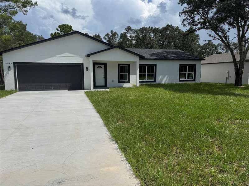 Front exterior of a new home in , Dunnellon, FL, highlighting curb appeal (Image 12).