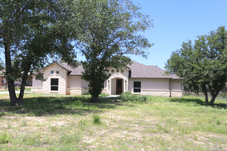 Front exterior of a new home in , Floresville, TX, highlighting curb appeal (Image 26).