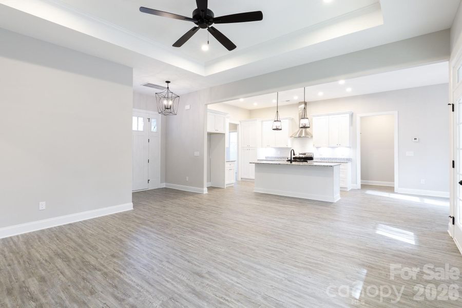 Large family room with tray ceiling with fan. Large family room with tray ceiling with fan.