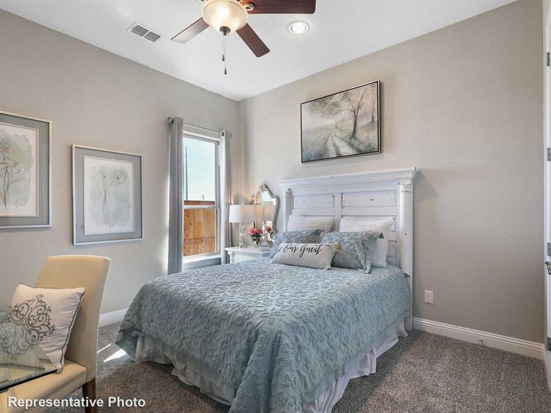 Carpeted bedroom with ceiling fan