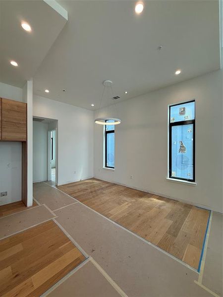 Empty room featuring wood finished floors and recessed lighting Empty room featuring wood finished floors and recessed lighting