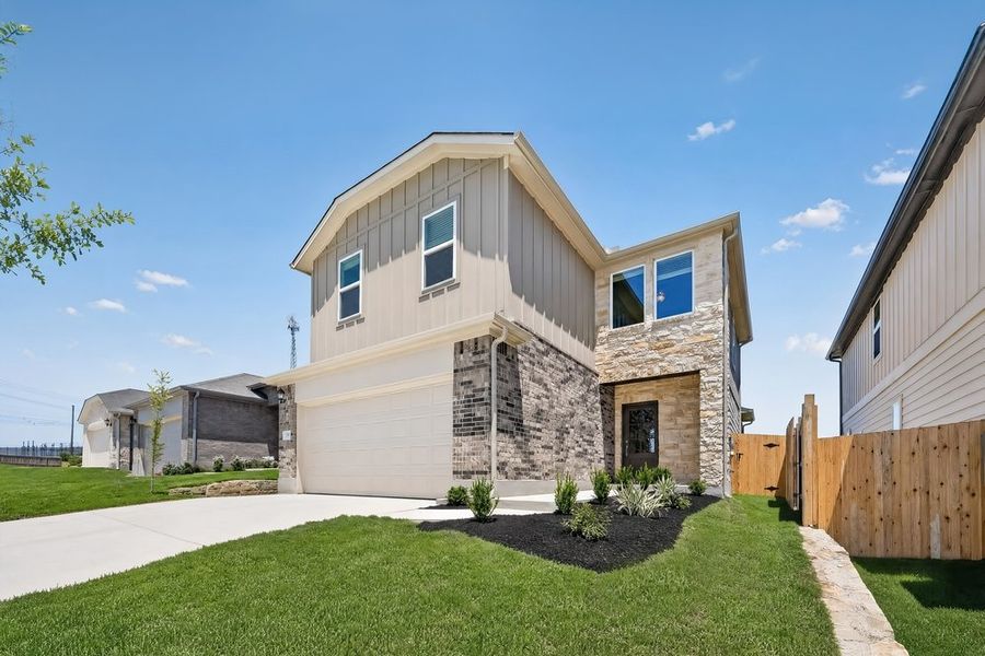 Front exterior of a new home in Sunfield, Buda, TX, highlighting curb appeal (Image 15). Front exterior of a new home in Sunfield, Buda, TX, highlighting curb appeal (Image 15).