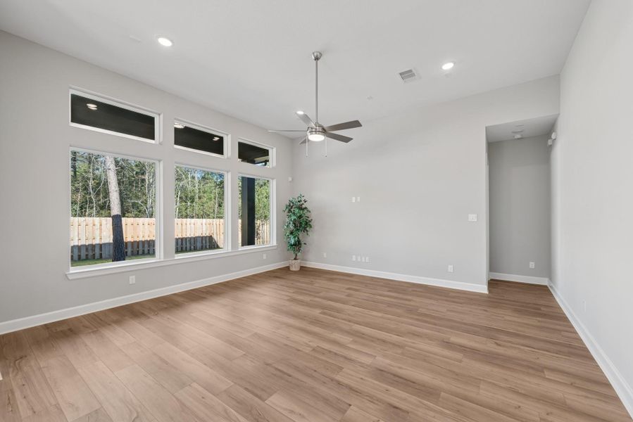 EXAMPLE PHOTO:  Spacious Living area with big windows  and low maintenance laminate flooring!  12 ft ceilings give it lots of flair!