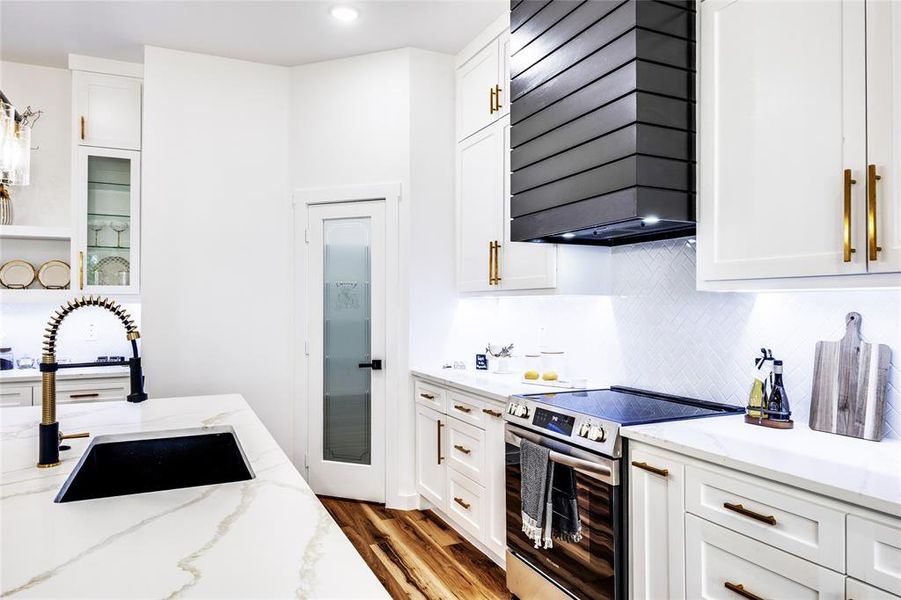 Kitchen featuring white cabinetry, electric range, dark wood-style floors, range hood, and backsplash