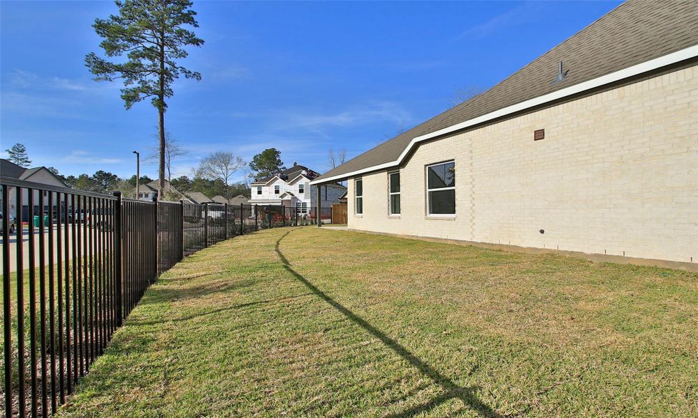 Exterior details and patio area of a home in The Woodlands Hills, Willis (Image 3).