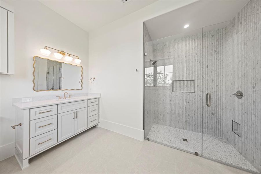 Bathroom featuring vanity, a shower stall, recessed lighting, and light tile patterned floors