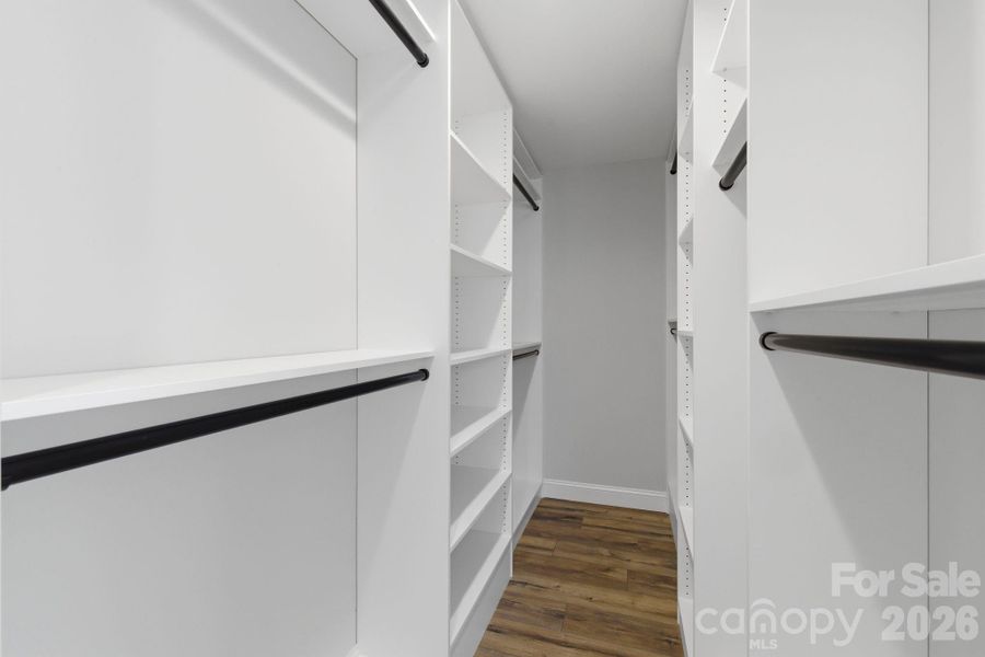 Primary suite featuring an expansive custom walk-in closet