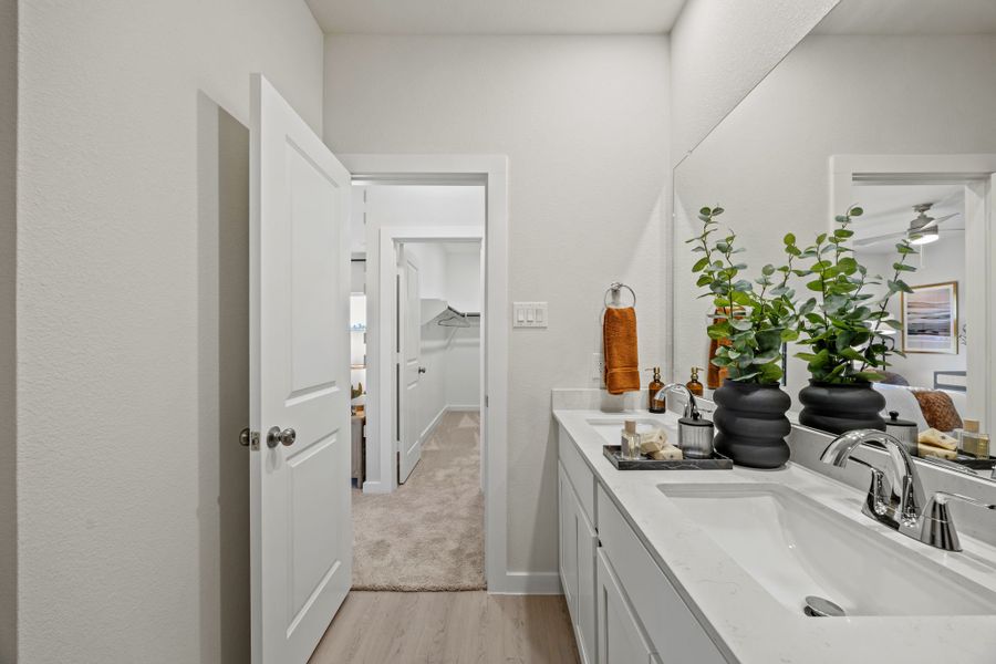 A bathroom with a sink and a mirror. A bathroom with a sink and a mirror.