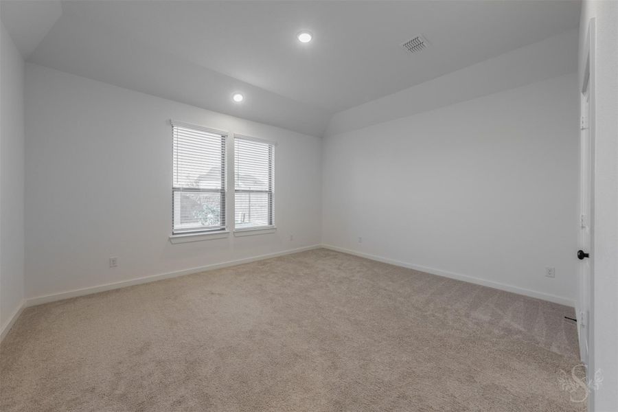 The spacious primary bedroom offers soft natural light and a serene atmosphere—an ideal retreat at the end of the day. Neutral tones and plush carpeting create a warm, inviting setting ready for your personal style. The spacious primary bedroom offers soft natural light and a serene atmosphere—an ideal retreat at the end of the day. Neutral tones and plush carpeting create a warm, inviting setting ready for your personal style.