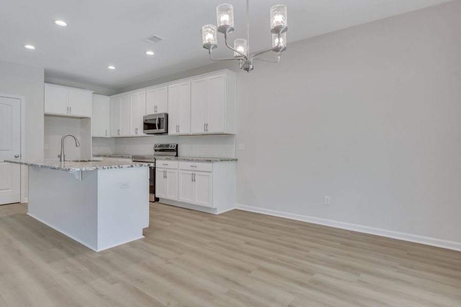Representative furnished interior of a home built from the The Hatteras by Smith Family Homes in Ramsey Landing, Rincon (Image 11).
