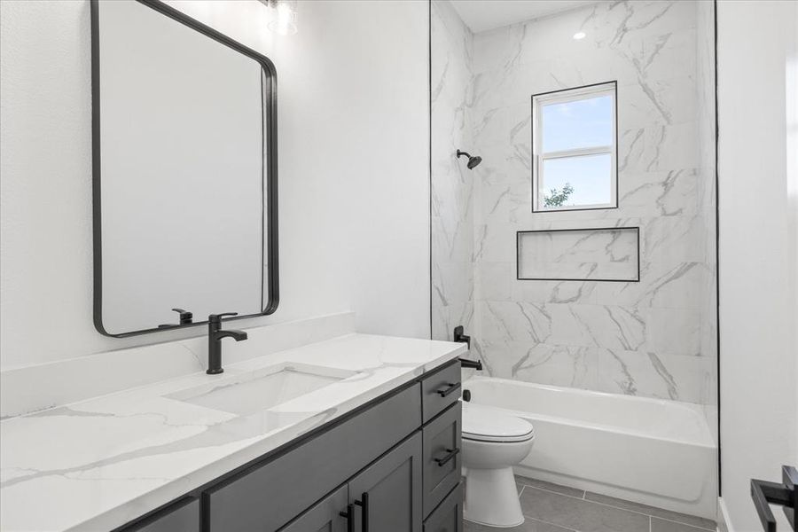 Contemporary Kids/Guest bathroom featuring a dark vanity with a white countertop, an integrated rectangular sink, and matte black fixtures