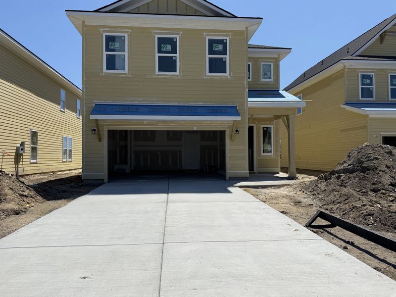 Front exterior of a new home in Blue Heron Retreat, Little River, SC, highlighting curb appeal (Image 2). Front exterior of a new home in Blue Heron Retreat, Little River, SC, highlighting curb appeal (Image 2).