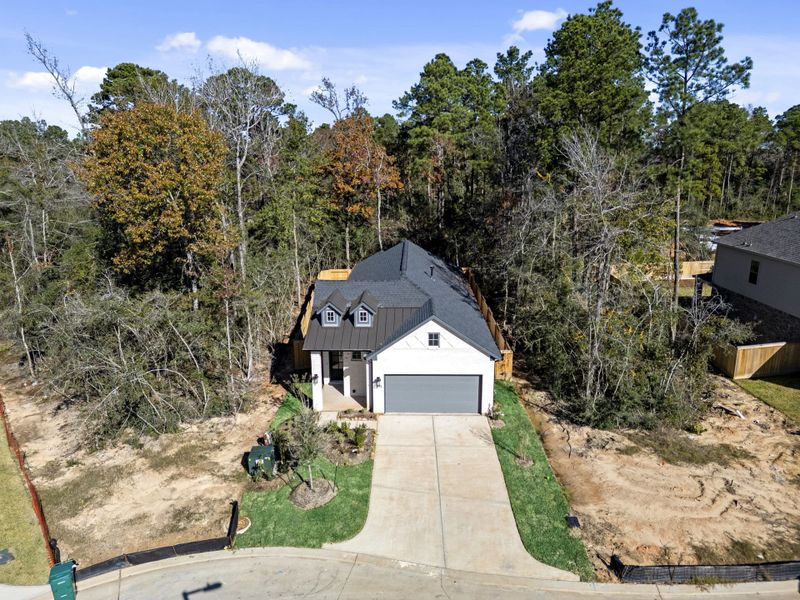 Front exterior of a new home in The Woodlands Hills, Willis, TX, highlighting curb appeal (Image 29). Front exterior of a new home in The Woodlands Hills, Willis, TX, highlighting curb appeal (Image 29).