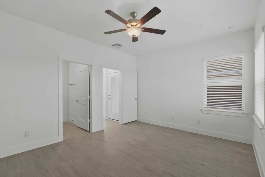 Representative unfurnished interior of a home built from the Carriagehouse by Chesmar Homes in Meridiana Townhomes, Iowa Colony (Image 95).