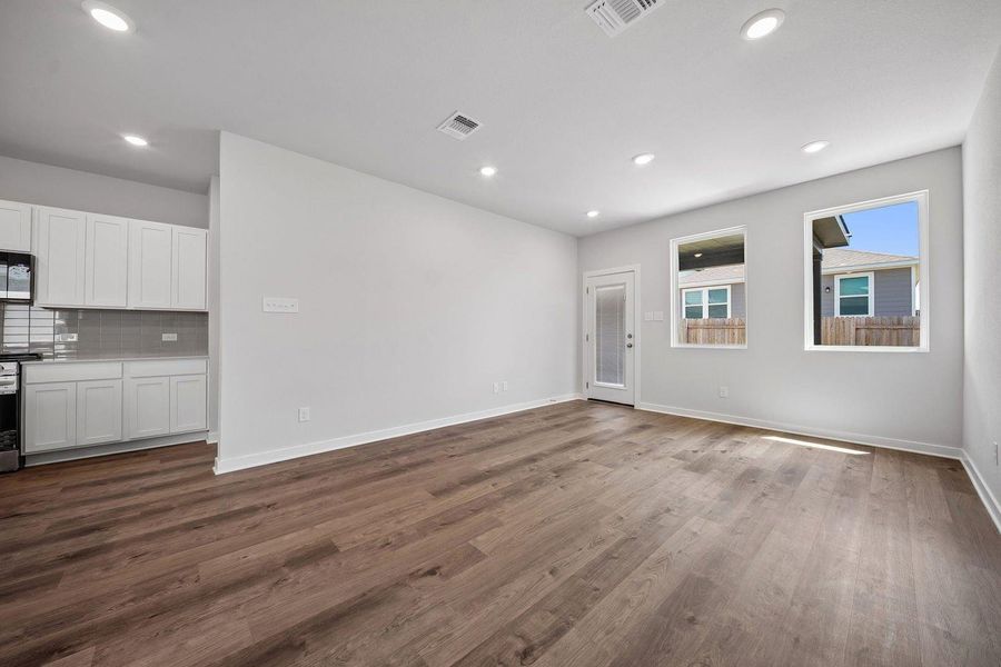 Hardwood floors and recessed lighting grace this contemporary great room. Hardwood floors and recessed lighting grace this contemporary great room.