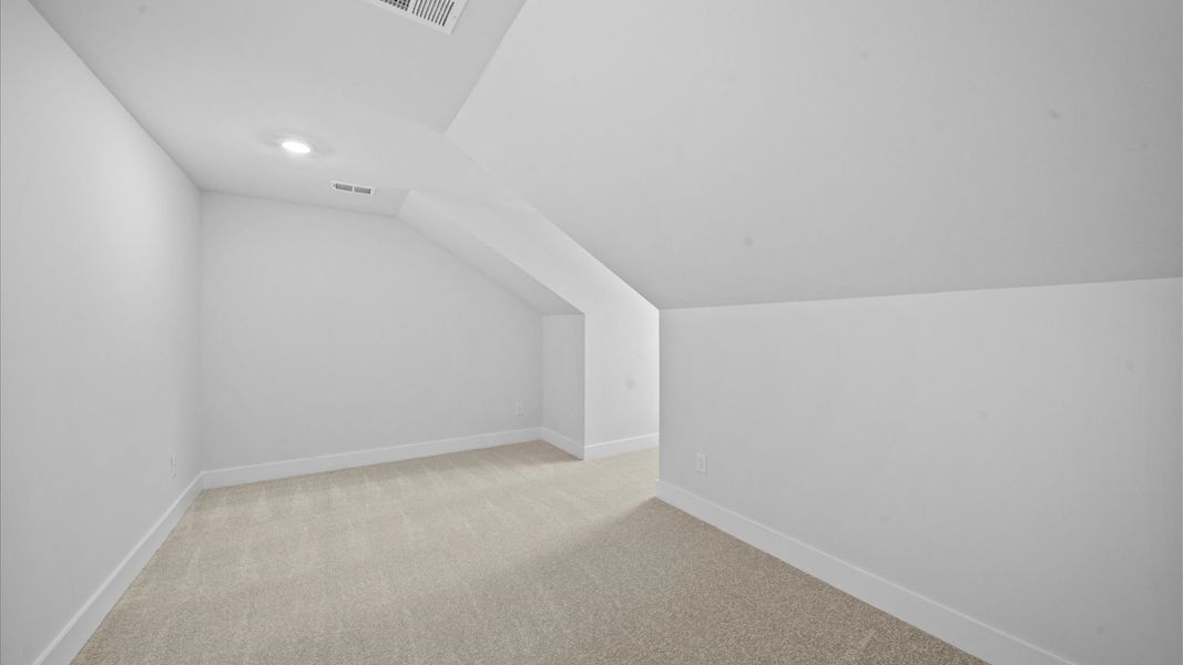 Vibrant carpeted loft offering flexibility as a study nook, game room, or second family space Vibrant carpeted loft offering flexibility as a study nook, game room, or second family space