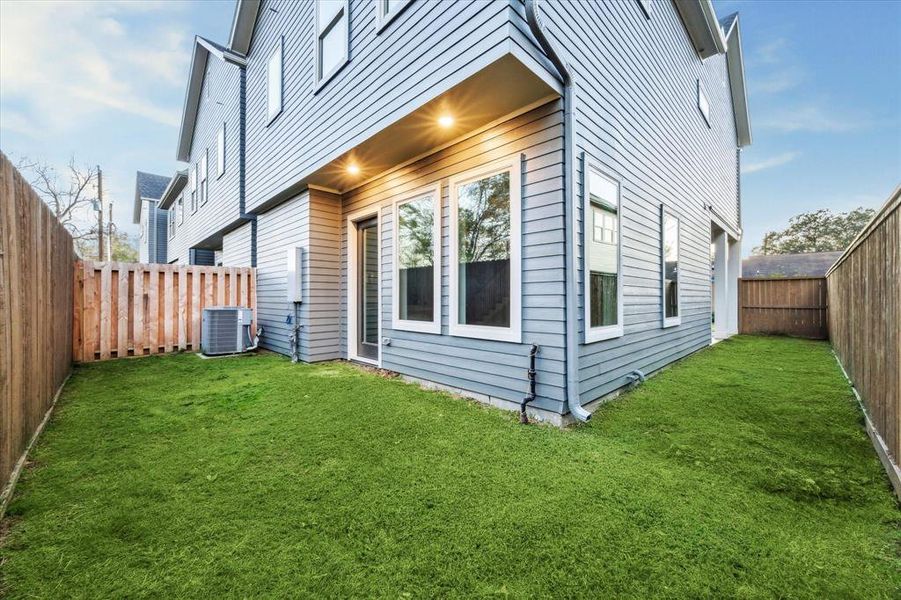 Back yard space is fully fenced with entry to living area.