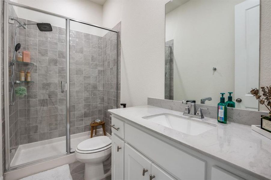 Bathroom featuring a stall shower and vanity Bathroom featuring a stall shower and vanity