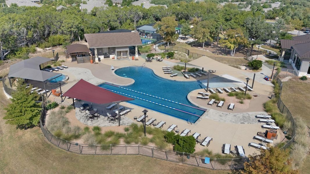 Expansive community pool area featuring multiple swimming pools, a lap lane, and extensive surrounding decking Expansive community pool area featuring multiple swimming pools, a lap lane, and extensive surrounding decking