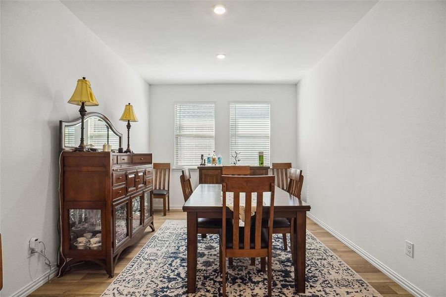 Dining space with hardwood / wood-style flooring