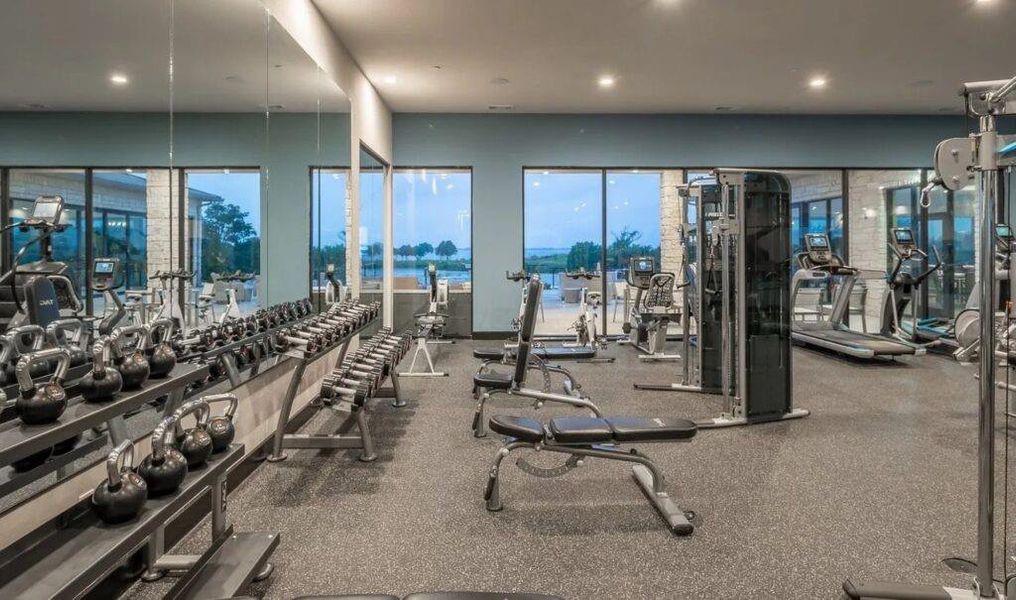 Exercise room with a water view and recessed lighting Exercise room with a water view and recessed lighting