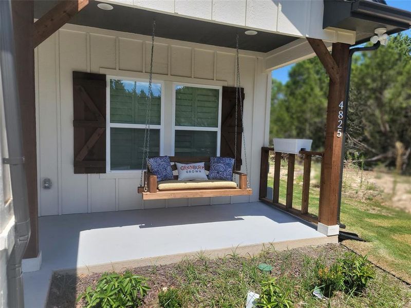 Front of porch with oversized front porch and wooden swing to enjoy summertime sunrises and sunsets. Front of porch with oversized front porch and wooden swing to enjoy summertime sunrises and sunsets.