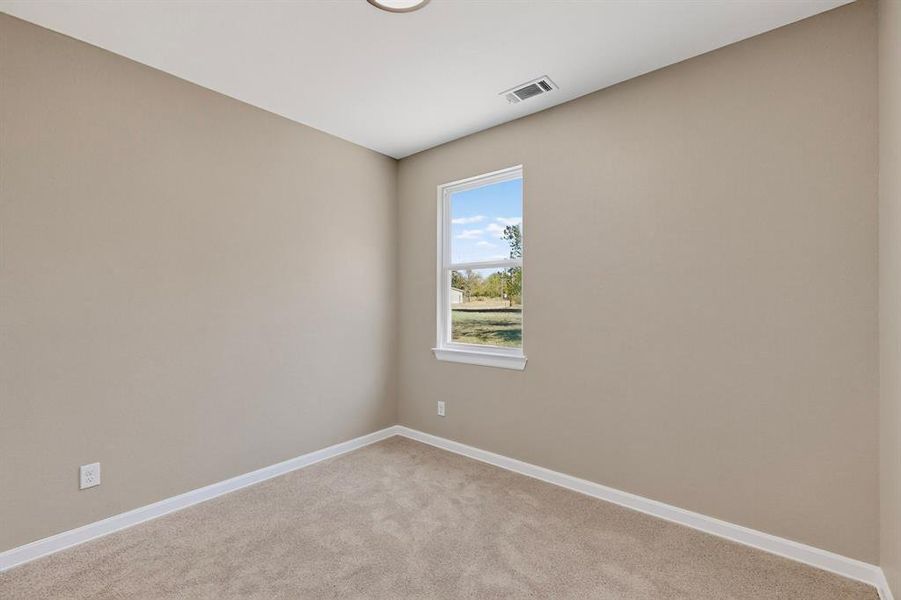 Spare room with baseboards and light colored carpet Spare room with baseboards and light colored carpet