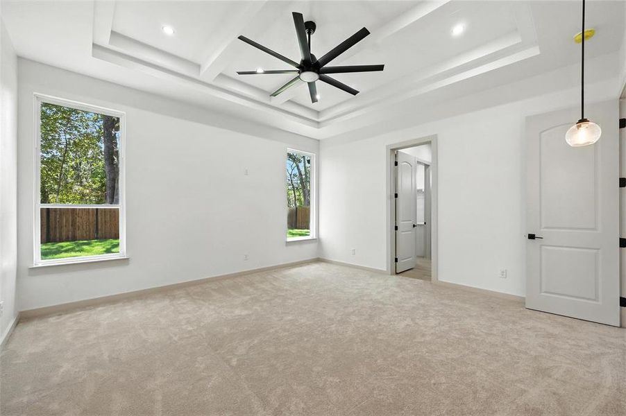 Unfurnished bedroom featuring carpet, recessed lighting, beam ceiling, and a raised ceiling Unfurnished bedroom featuring carpet, recessed lighting, beam ceiling, and a raised ceiling