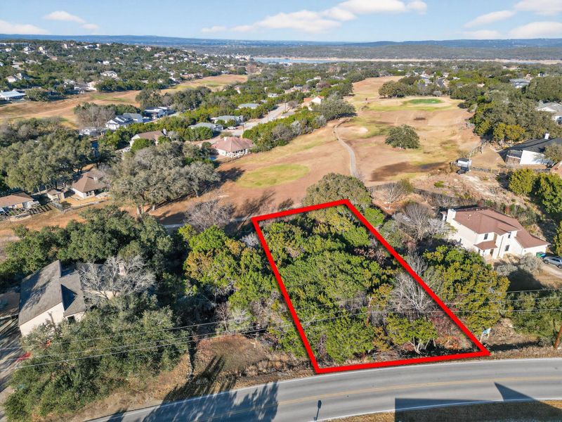 Aerial view of property's location with approximate property parcel outlined and nearby suburban area