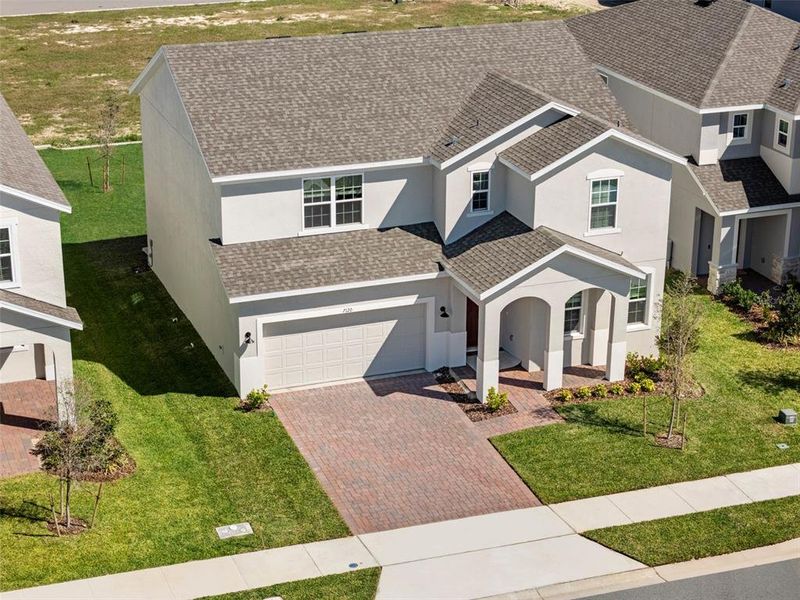 Front exterior of a new home in Trinity Lakes, Groveland, FL, highlighting curb appeal (Image 14).