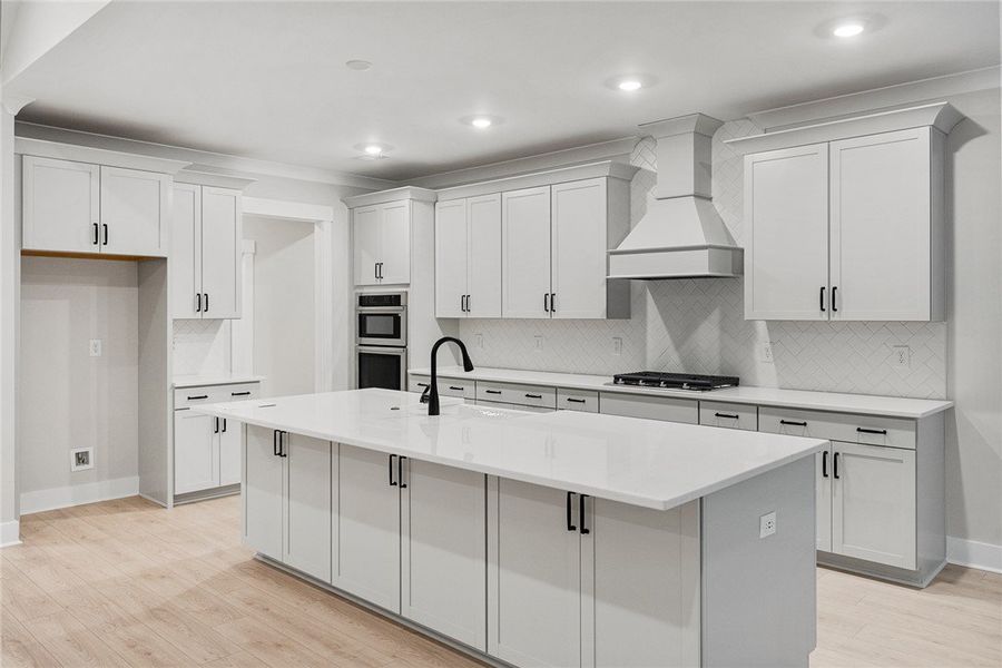 A well-appointed kitchen features a large central A well-appointed kitchen features a large central