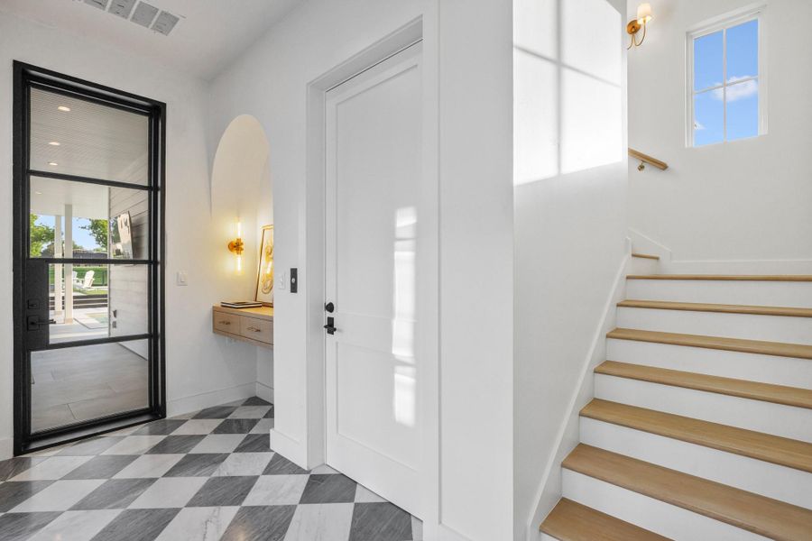Bold checkered flooring and an inviting archway welcome visitors into this luminous entry. Bold checkered flooring and an inviting archway welcome visitors into this luminous entry.
