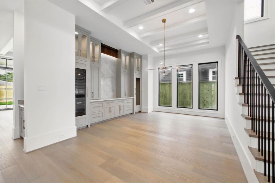 Sample of builder's previous construction. This home will have a similar dining room layout as pictured here. There will be a bar with built-ins and wine refrigeration and a ceiling treatment. Buyer still has time to select finishes. High-end appliance package will be used.